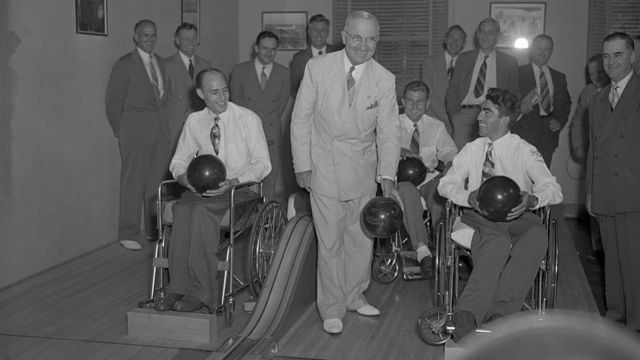 President Truman presents awards to three paralysed bowling champions at the White House